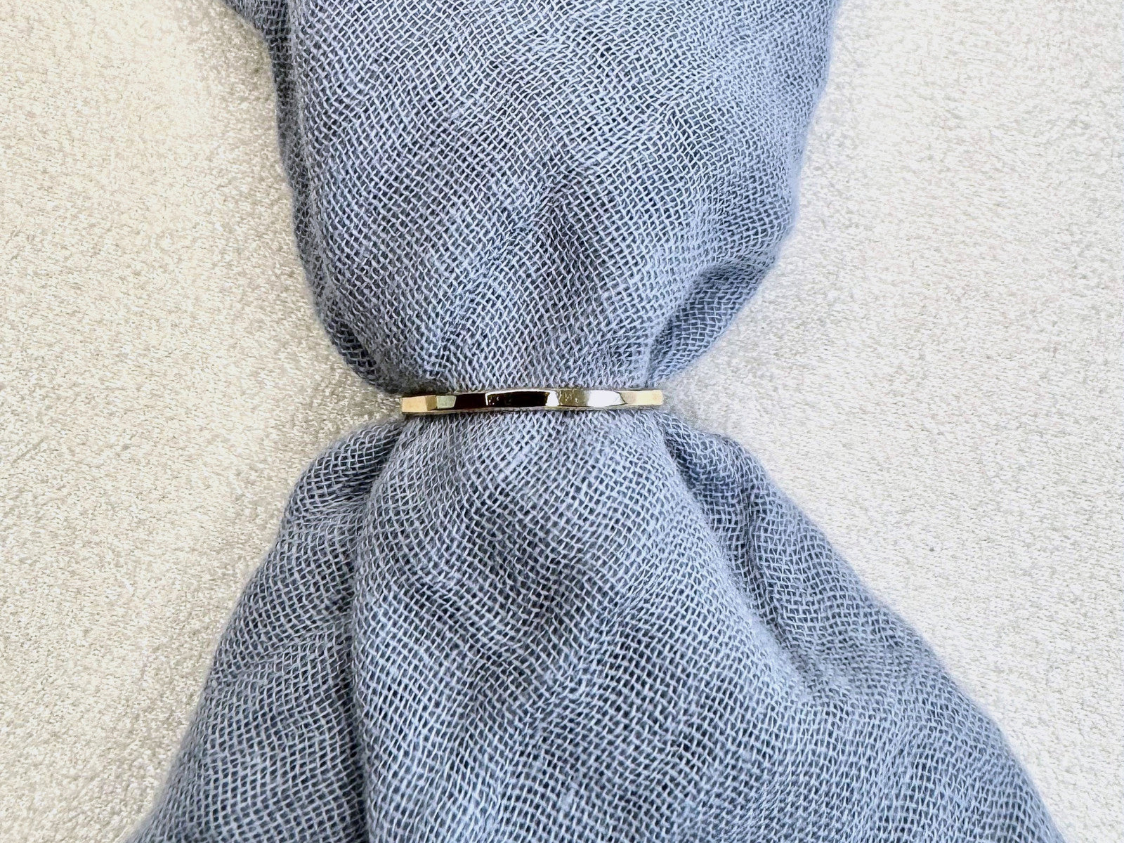 Hammered gold-fill band on grey linen